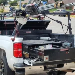 A white work truck for B & W full of tools and garage door openers